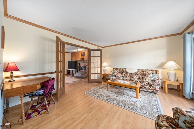 living room featuring wood finished floors, french doors, and ornamental molding