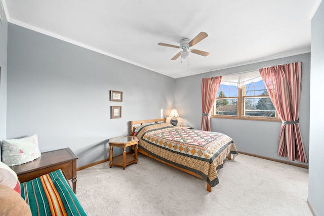 carpeted bedroom with baseboards, ornamental molding, and a ceiling fan