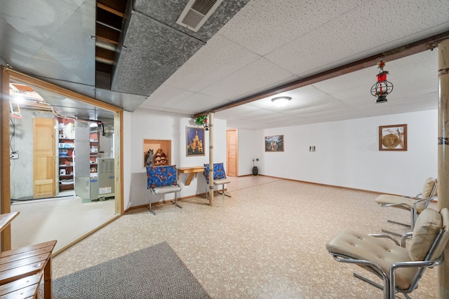 interior space with baseboards, visible vents, and a drop ceiling