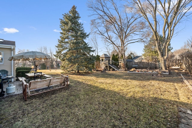 view of yard with a patio, a playground, and fence