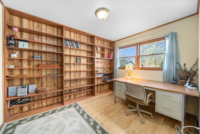 office featuring built in desk and light wood-style flooring