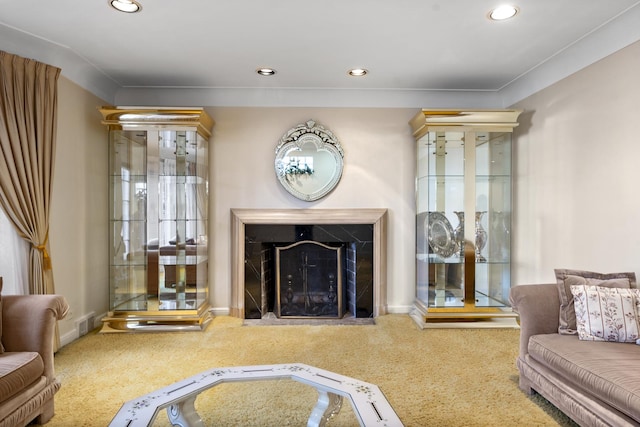 carpeted living room with recessed lighting, visible vents, baseboards, and a high end fireplace