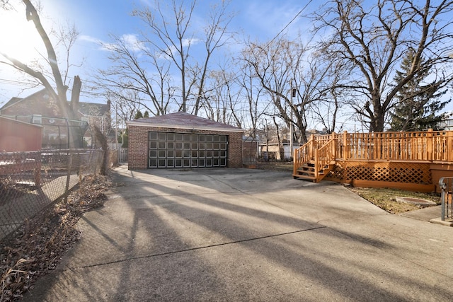 detached garage featuring fence