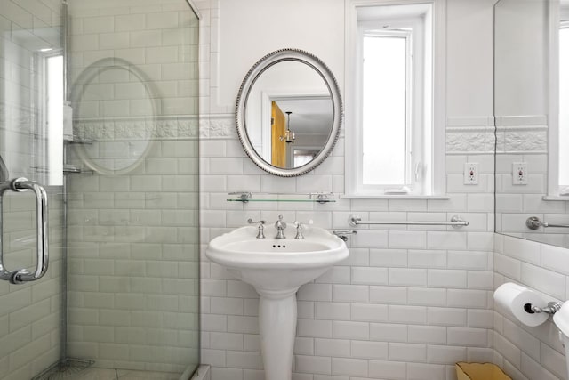 bathroom with tile walls and a stall shower