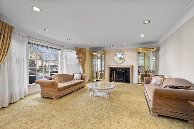 living room featuring a fireplace with flush hearth, carpet, recessed lighting, and ornamental molding