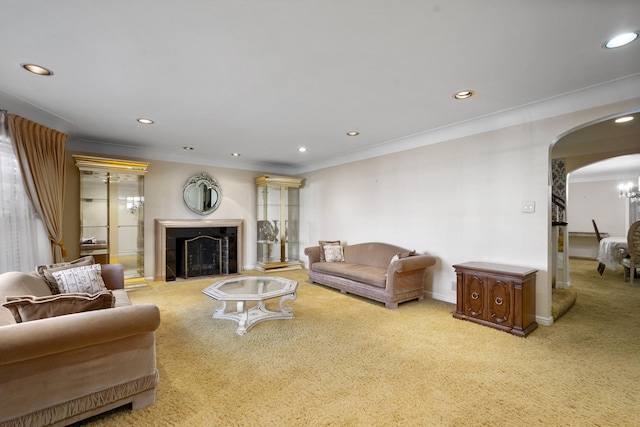 living room with ornamental molding, recessed lighting, arched walkways, carpet floors, and a tile fireplace