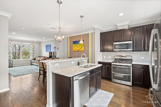 kitchen featuring stainless steel appliances, a sink, crown molding, dark brown cabinets, and dark wood finished floors