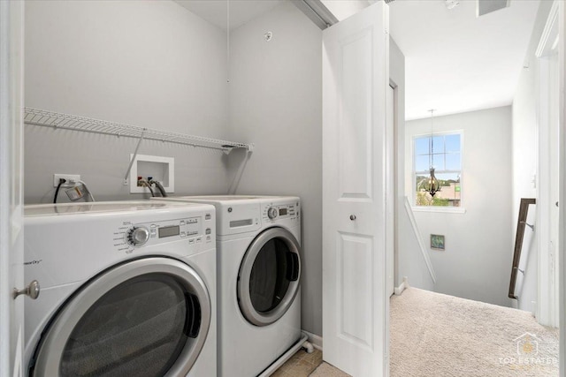 laundry area featuring washer and clothes dryer, light carpet, and baseboards