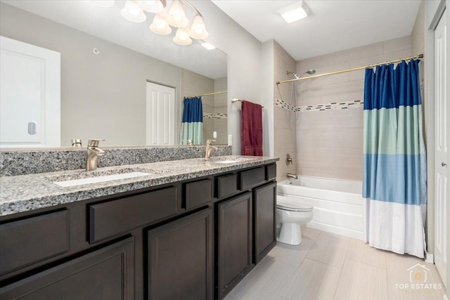 bathroom with shower / bath combination with curtain, toilet, double vanity, and a chandelier