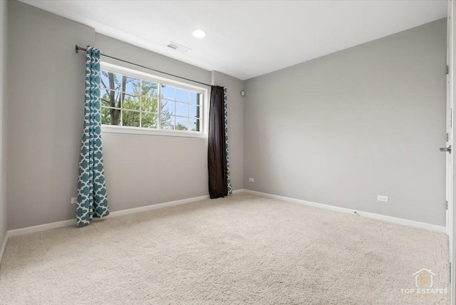 empty room featuring carpet flooring, baseboards, and recessed lighting