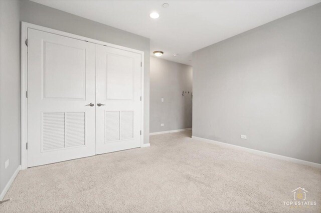 unfurnished bedroom featuring carpet, baseboards, a closet, and recessed lighting