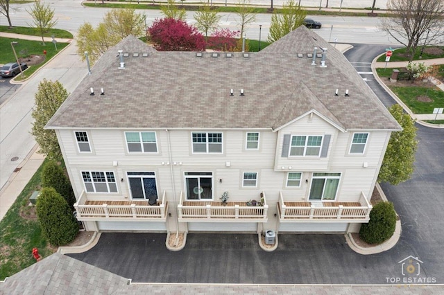 rear view of property with a shingled roof