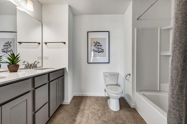 bathroom with tile patterned floors, toilet, a sink, double vanity, and baseboards