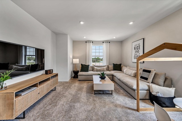 carpeted living area featuring recessed lighting and baseboards