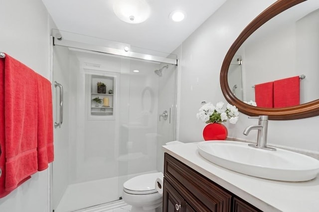 full bathroom with vanity, toilet, and a shower stall