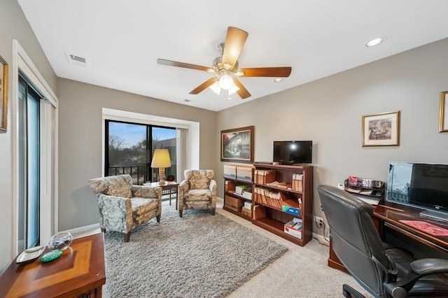 office featuring visible vents, a ceiling fan, recessed lighting, baseboards, and light colored carpet