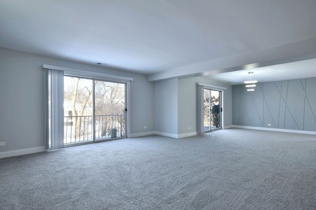 spare room featuring baseboards and carpet floors