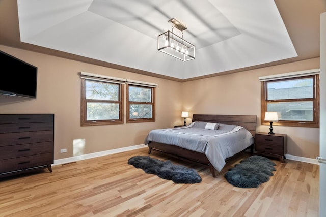 871 Woodcrest Ln, Lemont, IL 60439 - bedroom featuring a tray ceiling, baseboards, multiple windows, and wood finished floors