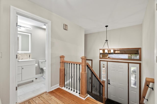 871 Woodcrest Ln, Lemont, IL 60439 - foyer with wood finished floors, a chandelier, and baseboards