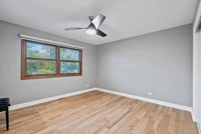 871 Woodcrest Ln, Lemont, IL 60439 - spare room with baseboards, light wood finished floors, and ceiling fan