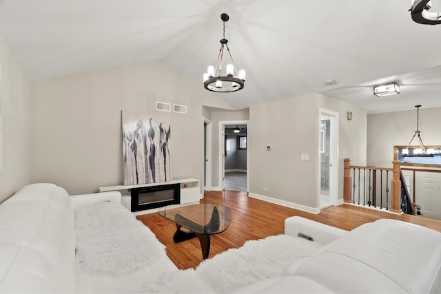 871 Woodcrest Ln, Lemont, IL 60439 - living room featuring a chandelier, wood finished floors, baseboards, and lofted ceiling