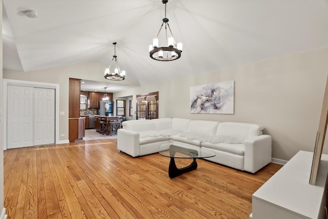 871 Woodcrest Ln, Lemont, IL 60439 - living area with a chandelier, light wood-style floors, lofted ceiling, and baseboards