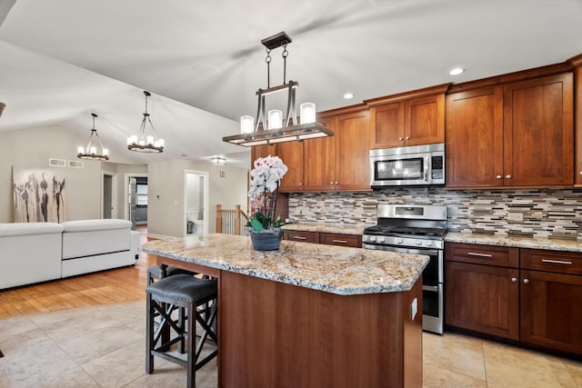 871 Woodcrest Ln, Lemont, IL 60439 - kitchen with appliances with stainless steel finishes, a chandelier, backsplash, a kitchen island, and lofted ceiling