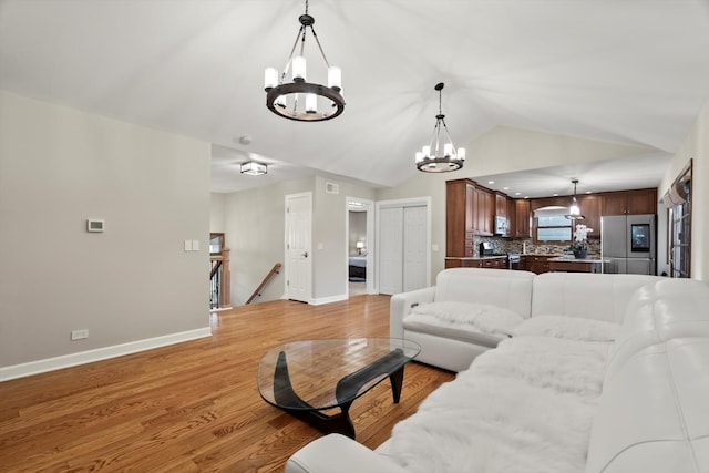 871 Woodcrest Ln, Lemont, IL 60439 - living area with a chandelier, lofted ceiling, baseboards, and light wood-style flooring