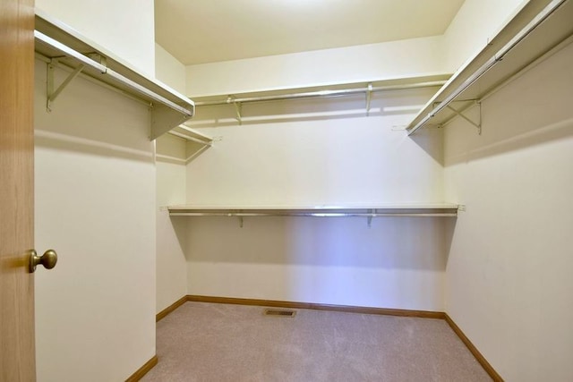 walk in closet with visible vents and carpet floors