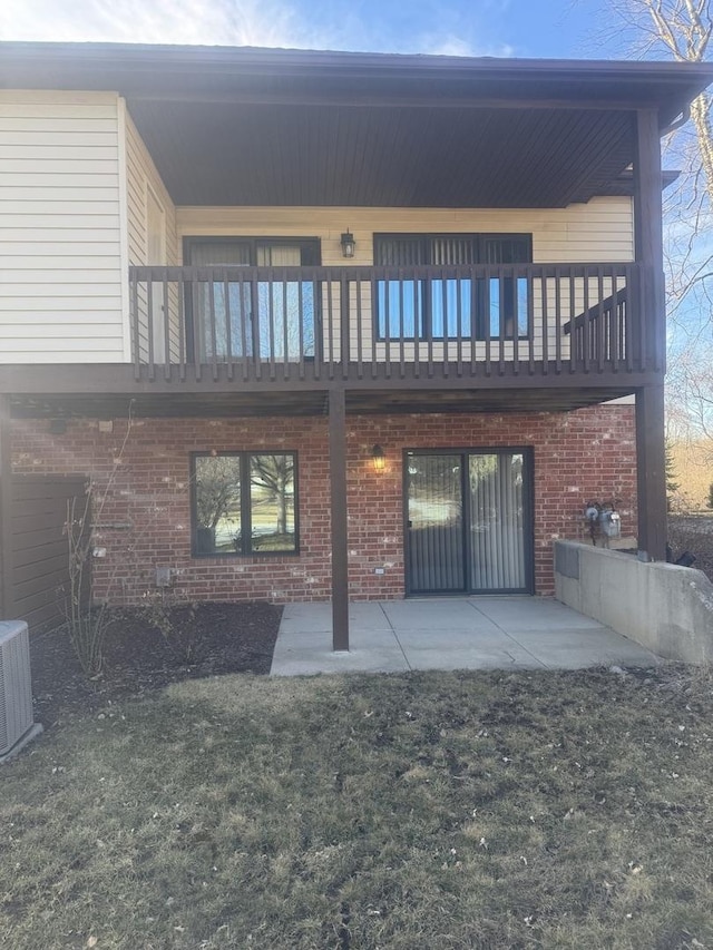 back of house with a patio area, central AC unit, and brick siding