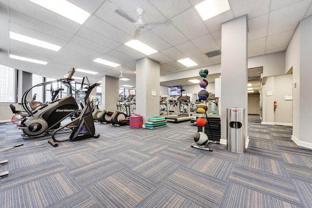 workout area with a paneled ceiling, baseboards, ceiling fan, and carpet flooring