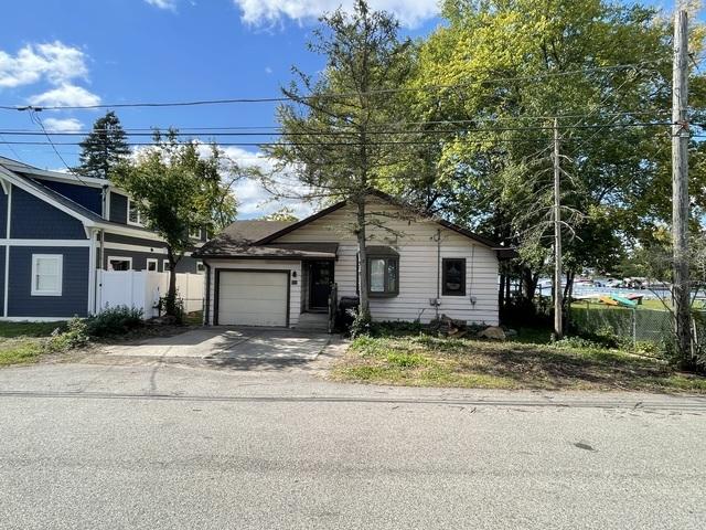 view of front of home with an attached garage, fence, and driveway