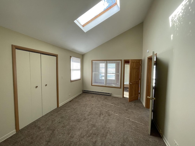 unfurnished bedroom featuring a baseboard radiator, high vaulted ceiling, a skylight, and carpet flooring