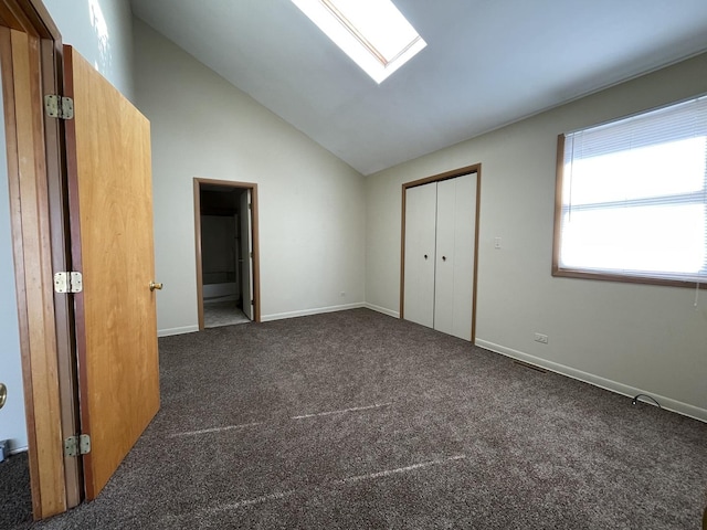 unfurnished bedroom featuring baseboards, carpet, and a skylight