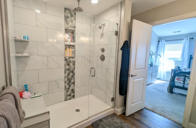1617 Oliger Dr, Mahomet, IL 61853 - full bathroom featuring visible vents, wood finished floors, and a stall shower