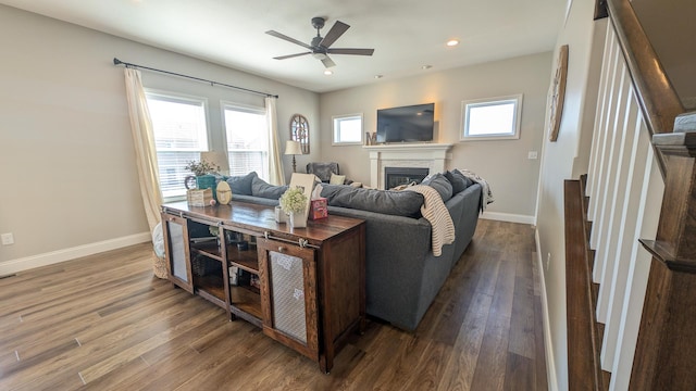 1617 Oliger Dr, Mahomet, IL 61853 - living area with a glass covered fireplace, wood finished floors, baseboards, and ceiling fan