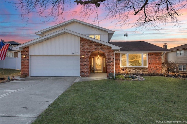 view of front of home featuring brick siding, a garage, concrete driveway, and a front lawn