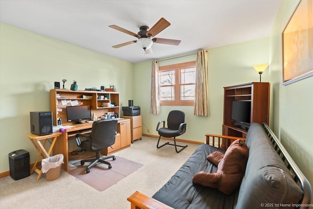 office featuring baseboards, light carpet, and a ceiling fan