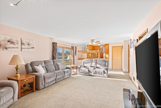 living room featuring carpet floors and ceiling fan