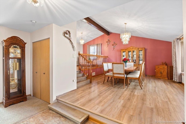 dining space with a chandelier, stairway, vaulted ceiling with beams, and wood finished floors