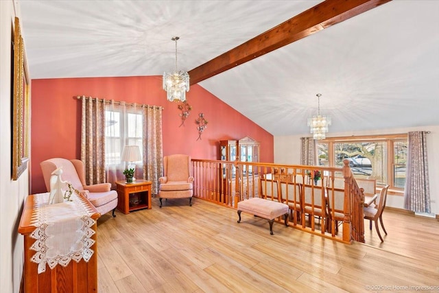 sitting room featuring wood finished floors, a chandelier, and vaulted ceiling with beams