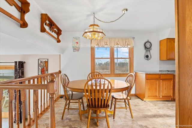 dining room with a notable chandelier and baseboards