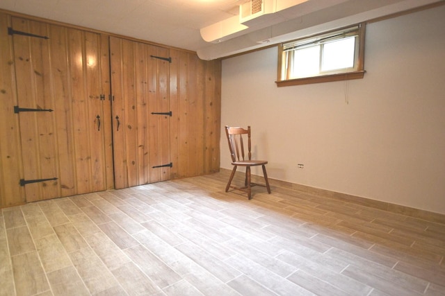 interior space featuring wooden walls, visible vents, and wood tiled floor