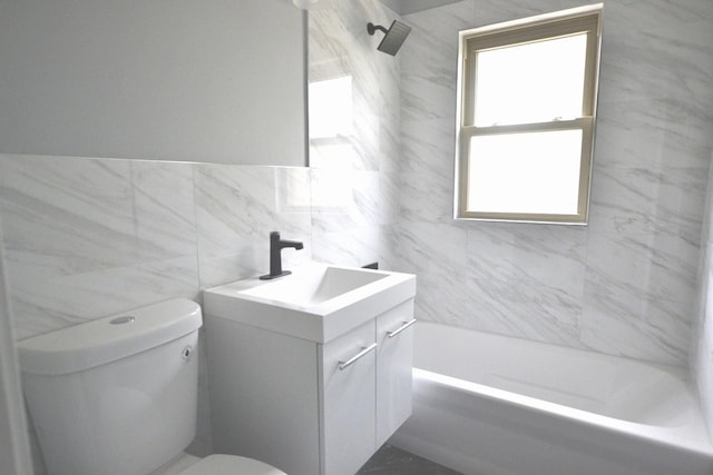 bathroom with tile walls, tub / shower combination, toilet, and vanity