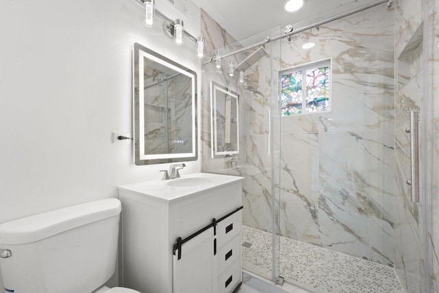 bathroom featuring vanity, toilet, and a marble finish shower