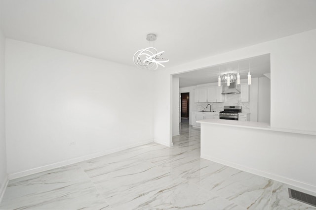 interior space with visible vents, baseboards, marble finish floor, and a chandelier