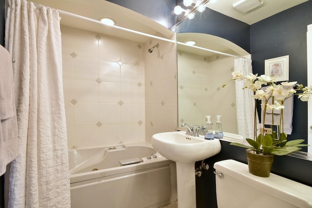 full bath featuring tile walls, toilet, and shower / bath combo