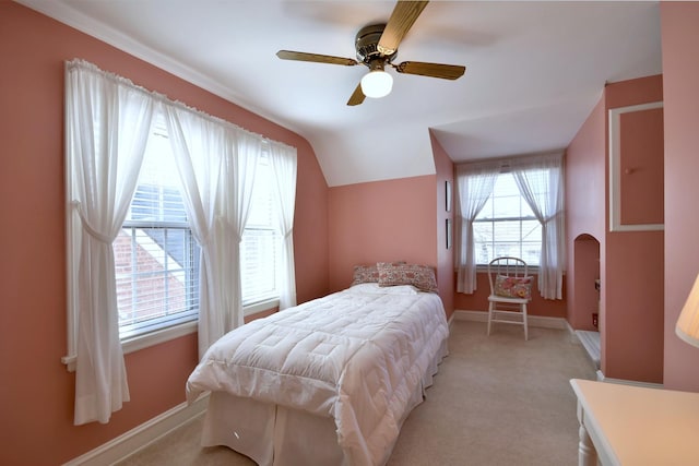 bedroom featuring baseboards, lofted ceiling, light colored carpet, and ceiling fan