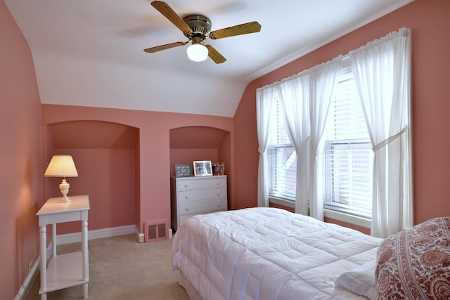 bedroom featuring visible vents, baseboards, lofted ceiling, light carpet, and a ceiling fan