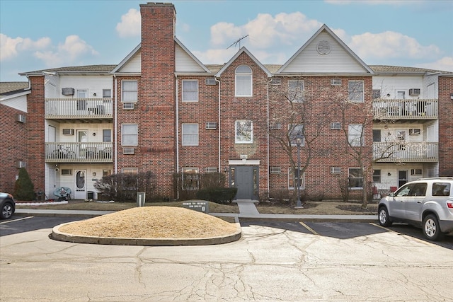 view of building exterior featuring uncovered parking